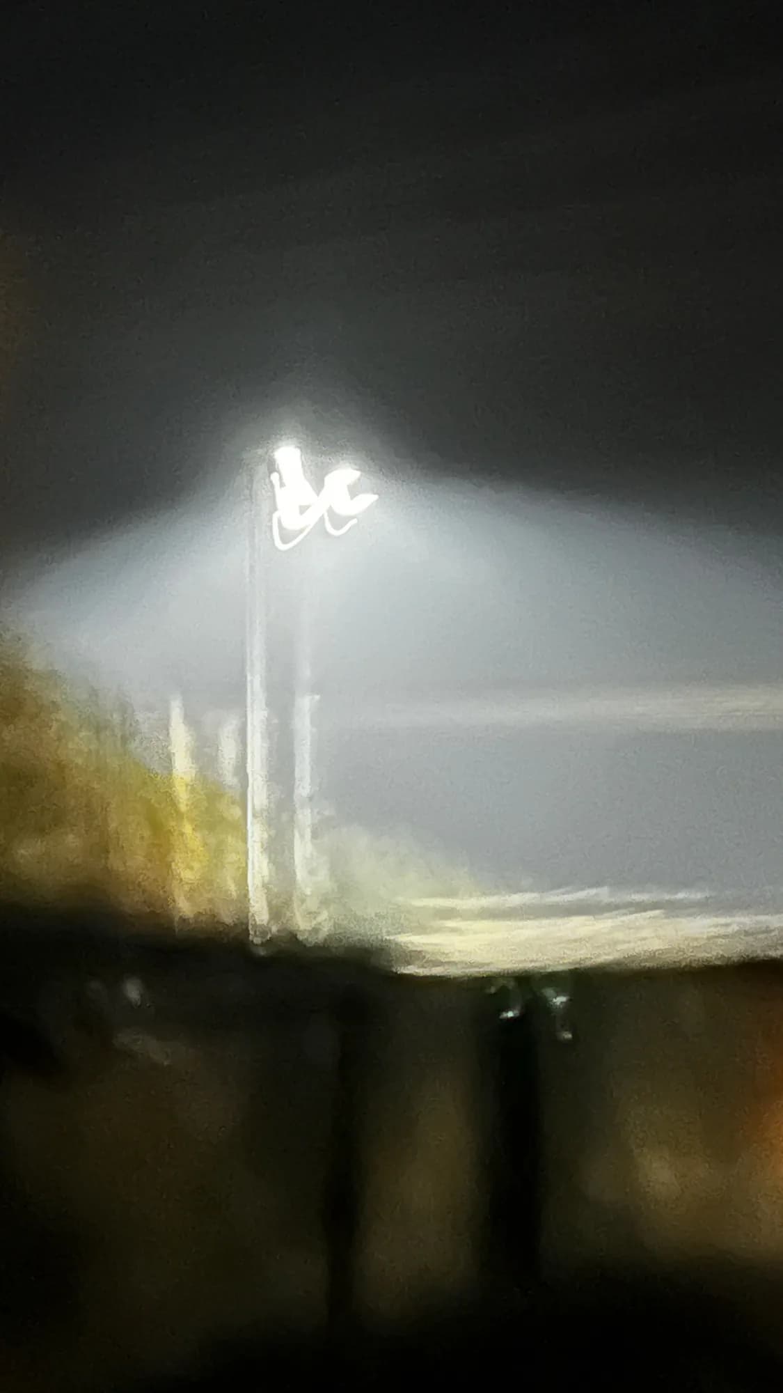 A light glowing through fog at night