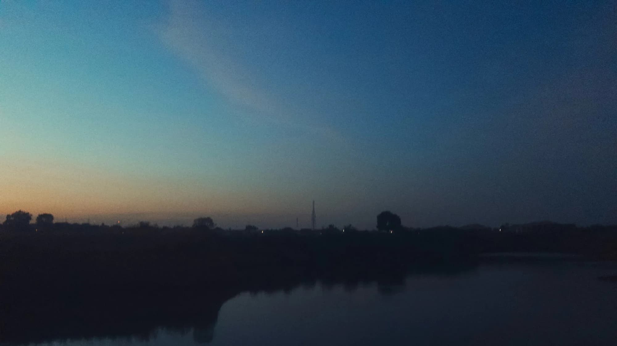 A lake at dusk with the last light on the horizon
