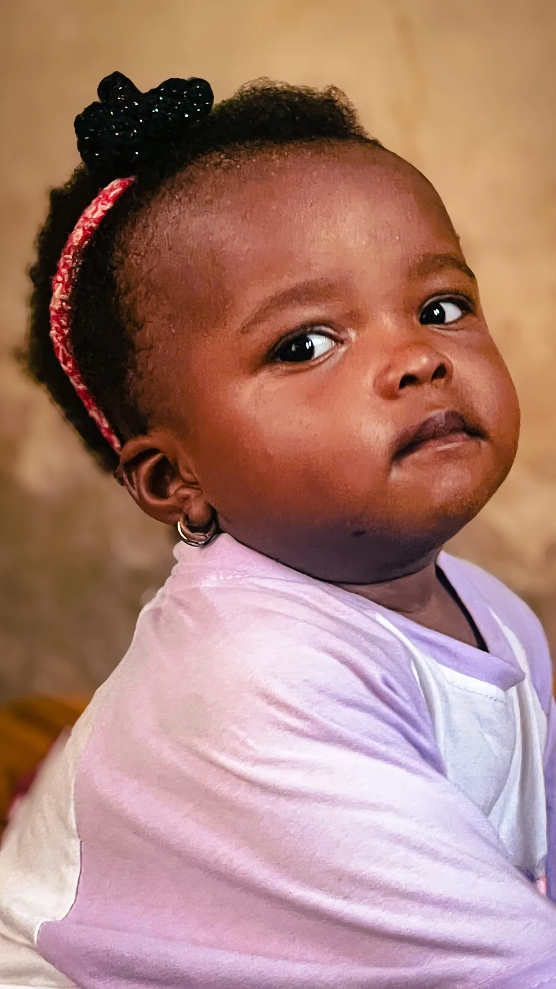 My niece in her red headband, looking over her shoulder