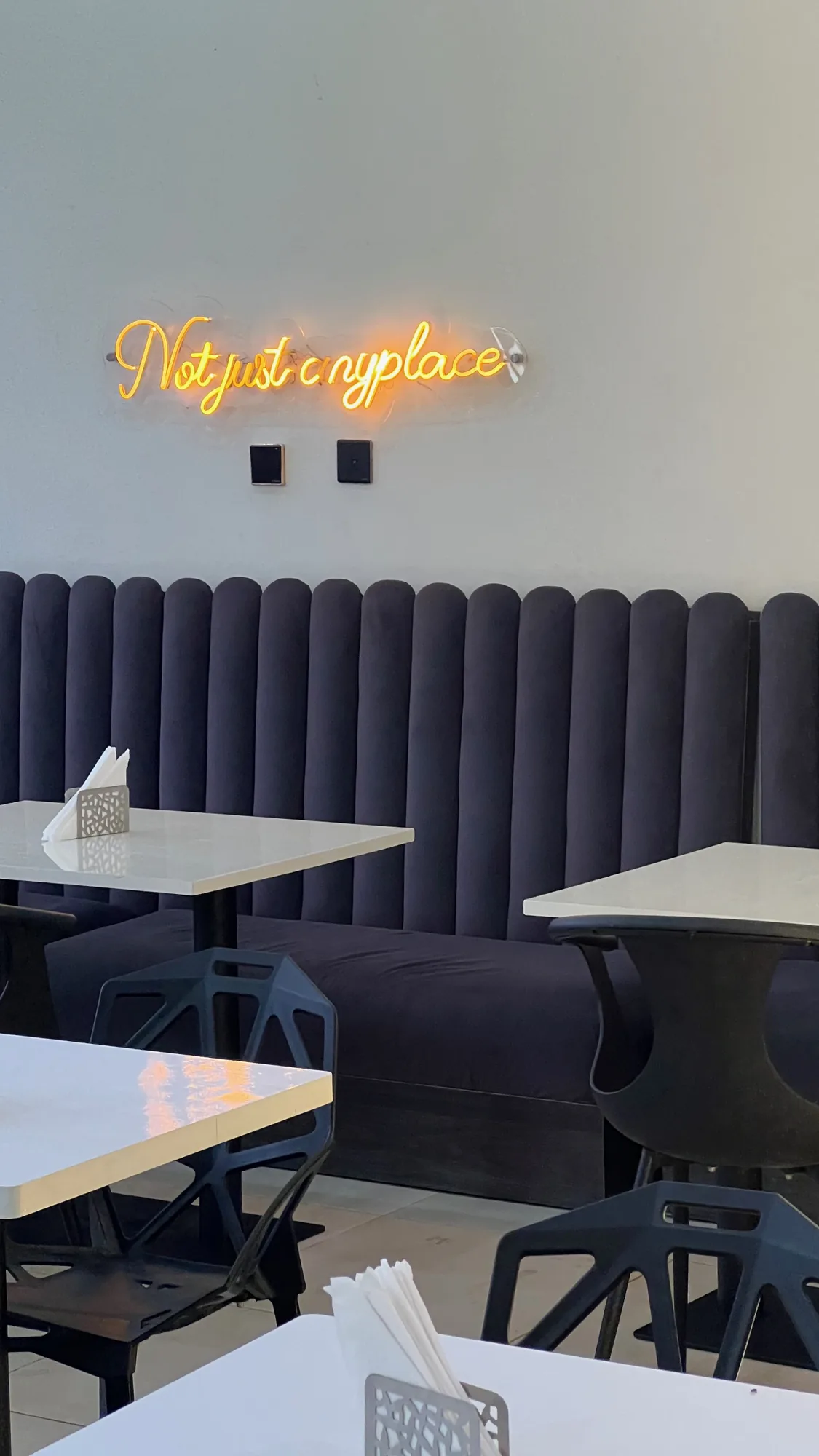 A neon sign over an empty café
