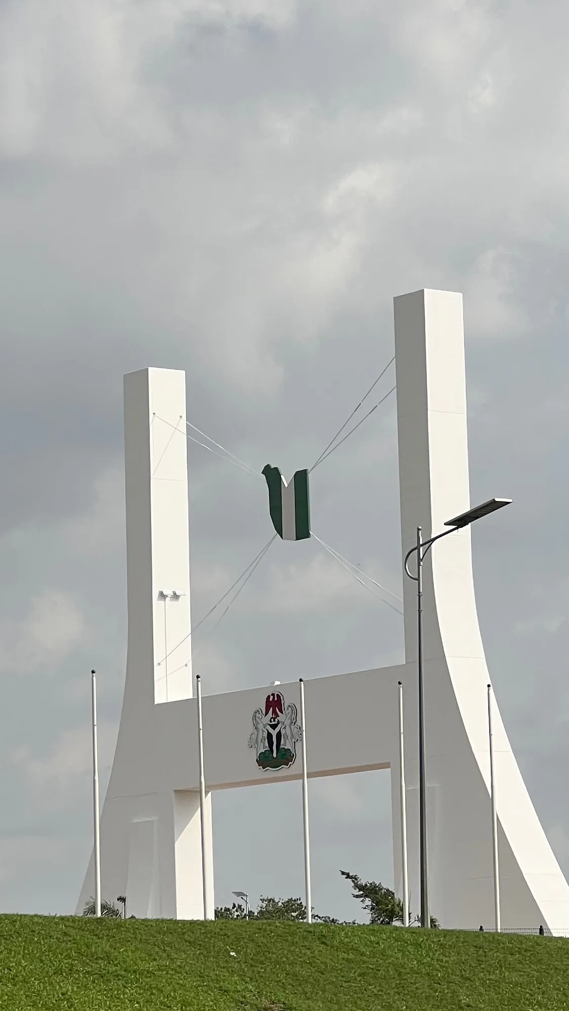 The City Gate in Abuja under a grey sky