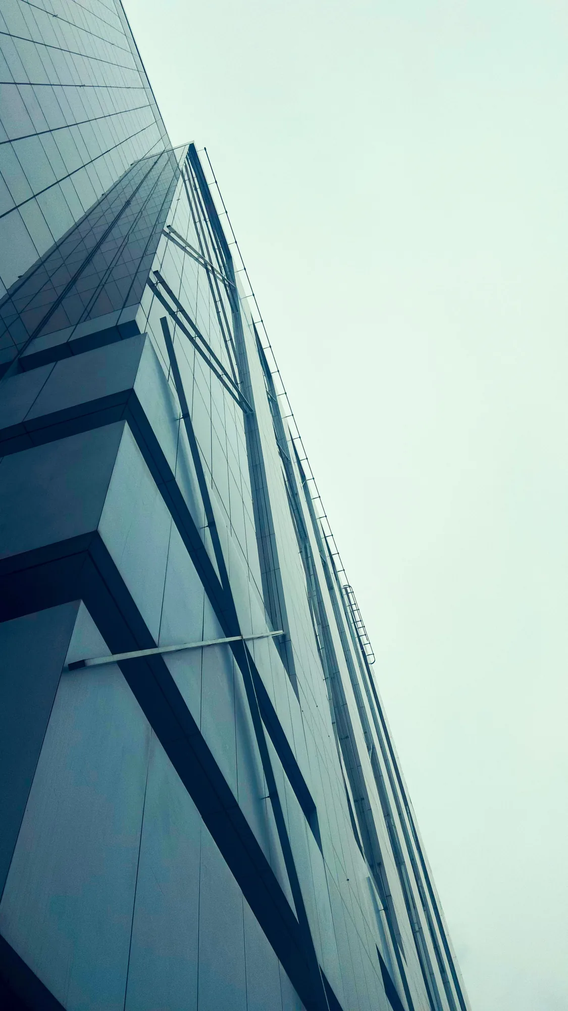 Looking up a glass building into the sky
